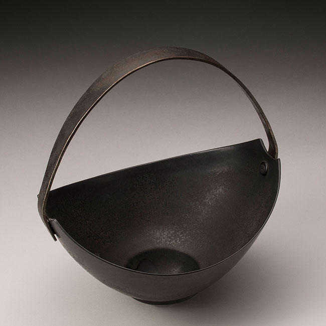 hand-thrown porcelain clay vessel with black matt glaze and wrought iron handle